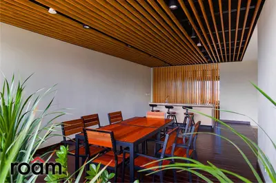 a dining room with a wooden table and chairs at Datum Jelatek Sky Residence Kuala Lumpur, Roam in Kuala Lumpur