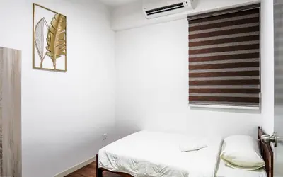 a white room with a bed and a window at M Vertica KL by Airhost in Kuala Lumpur