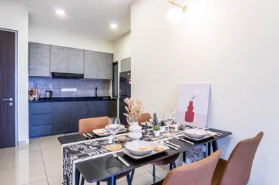 a dining room with a black table and chairs at M Vertica KL by Airhost in Kuala Lumpur