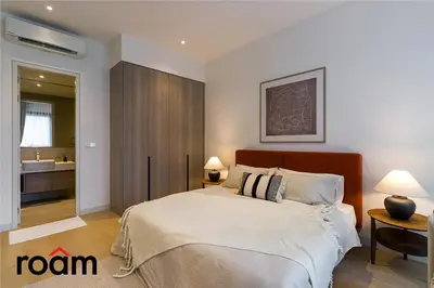 a bedroom with a large bed and a bathroom at ViiA Residences Kuala Lumpur in Kuala Lumpur