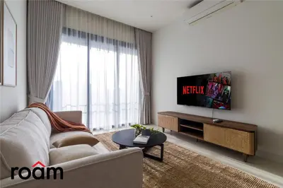 a living room with a couch and a flat screen tv at ViiA Residences Kuala Lumpur in Kuala Lumpur