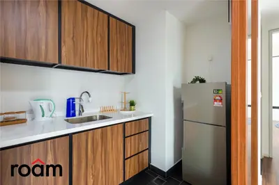 a kitchen with a refrigerator and a sink at UNA Residences, Sunway KL in Kuala Lumpur