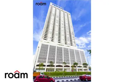 a tall white building with cars parked in front of it at UNA Residences, Sunway KL in Kuala Lumpur