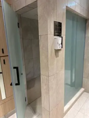 a shower with a glass door in a bathroom at Maxhome at Axon Bukit Bintang in Kuala Lumpur