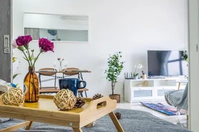 a living room with a table with flowers on it at Continew 1BR High TRX Mall King Bed 100Mbps Wi-Fi in Kuala Lumpur