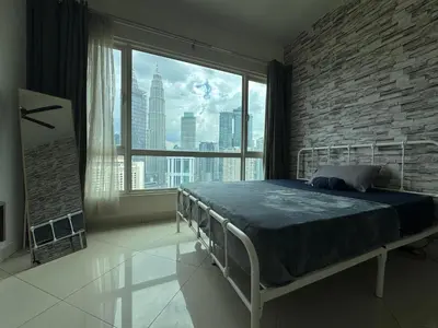 a bedroom with a bed and a large window at HaBiBi hOmE Klcc in Kuala Lumpur