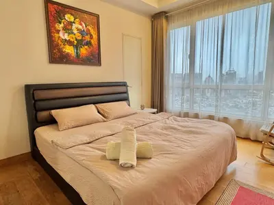 a bedroom with a large bed with two towels on it at HaBiBi hOmE Klcc in Kuala Lumpur