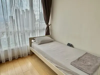 a small bed in a room with a window at HaBiBi hOmE Klcc in Kuala Lumpur