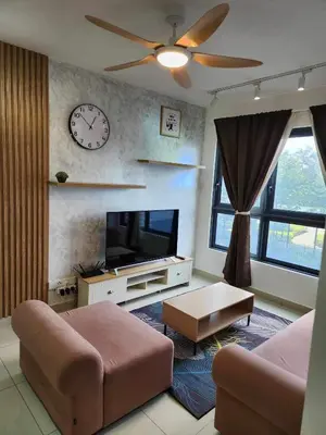 a living room with a couch and a clock on the wall at 5 mins to IKEA Mytown M Vertica Hanan Residence in Kuala Lumpur