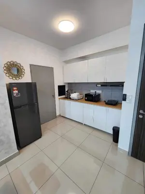a kitchen with a black refrigerator in a room at 5 mins to IKEA Mytown M Vertica Hanan Residence in Kuala Lumpur