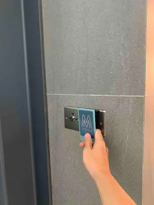 a person holding a sign in front of a bathroom mirror at 5 mins to IKEA Mytown M Vertica Hanan Residence in Kuala Lumpur