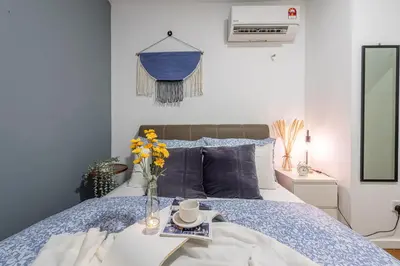 a bedroom with a bed with a vase of flowers on it at Bintang Fairlane Residences near Pavilion by GL Staycation in Kuala Lumpur