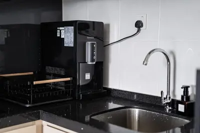 a kitchen counter with a sink and a microwave at Peaceful 2-bedroom for 6 Pax - Chan Sow Lin in Kuala Lumpur