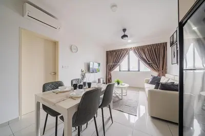 a dining room and living room with a table and chairs at Peaceful 2-bedroom for 6 Pax - Chan Sow Lin in Kuala Lumpur