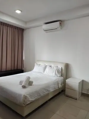 a bedroom with a white bed with a hat on it at Arte plus by sweet home studio in Kuala Lumpur