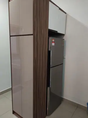 a kitchen with a refrigerator and a glass wall at Arte plus by sweet home studio in Kuala Lumpur