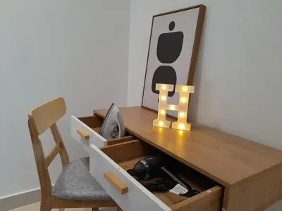 a wooden desk with a picture of an iphone on it at 2Room 6pax 2 min to # Chan Sow Lin # TRX #Velocity #KLCC in Kuala Lumpur