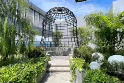 a bird cage in the middle of a garden at 2Room 6pax 2 min to # Chan Sow Lin # TRX #Velocity #KLCC in Kuala Lumpur