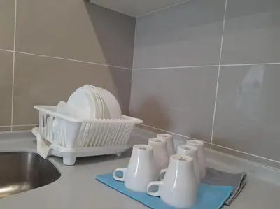 a kitchen counter with a sink and a bunch of dishes at 2Room 6pax 2 min to # Chan Sow Lin # TRX #Velocity #KLCC in Kuala Lumpur