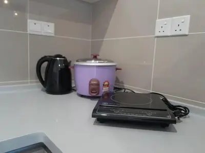 a toaster sitting on a kitchen counter with a toaster at 2Room 6pax 2 min to # Chan Sow Lin # TRX #Velocity #KLCC in Kuala Lumpur