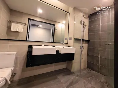 a bathroom with two sinks and a large mirror at The Roma at Dang Wangi Kuala Lumpur in Kuala Lumpur