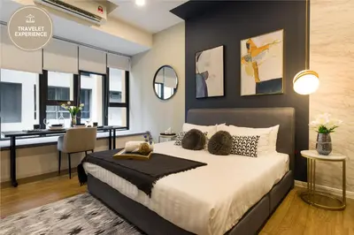 a bedroom with a king sized bed and a desk at Ceylonz Suite KLCC, Travelet in Kuala Lumpur