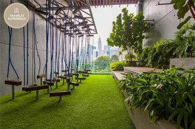 a row of benches in a building with plants at Ceylonz Suite KLCC, Travelet in Kuala Lumpur