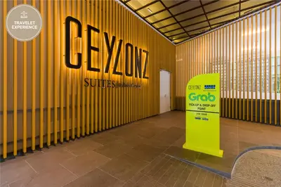 a room with a yellow wall with a sign on it at Ceylonz Suite KLCC, Travelet in Kuala Lumpur