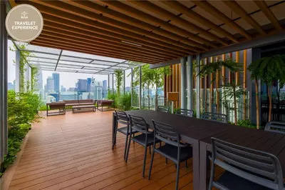 a balcony with a table and chairs on a building at Ceylonz Suite KLCC, Travelet in Kuala Lumpur