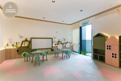 a room with a classroom with stools and a table at Scarletz Suites KLCC, Travelet in Kuala Lumpur