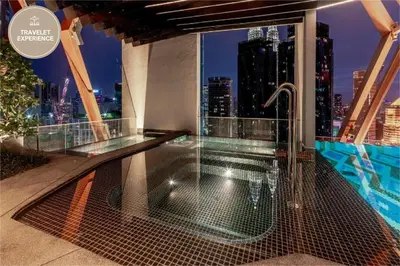a balcony with a view of a city skyline at Scarletz Suites KLCC, Travelet in Kuala Lumpur