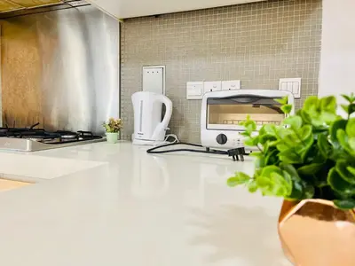 a kitchen with a sink and a counter with a microwave at #125 Bintang Fairlane KLCC - Lot 10 - Pavilion - Fahrenheit for 1-5px in Kuala Lumpur