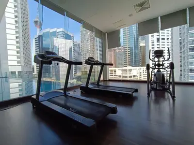 a gym with three exercise bikes in front of a window at RM2a18 Bukit Bintang Balcony Studio in Kuala Lumpur