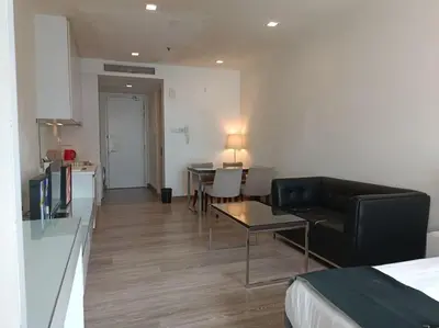 a living room with a couch and a table in a room at RM2a18 Bukit Bintang Balcony Studio in Kuala Lumpur