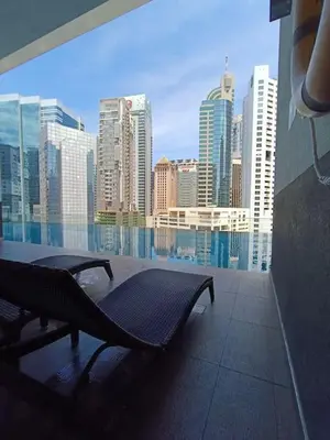 a bench on a balcony with a view of a city at RM2a18 Bukit Bintang Balcony Studio in Kuala Lumpur