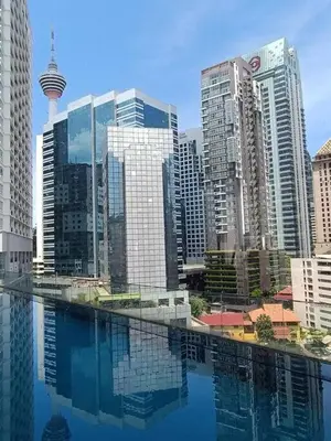 a city with a pool of water in front of buildings at RM203 Bukit Bintang Balcony Studio Infinity Pool in Kuala Lumpur
