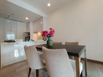 a dining room table with chairs and a vase of flowers at RM231 2Bedroom Bukit Bintang Balcony KL City View in Kuala Lumpur