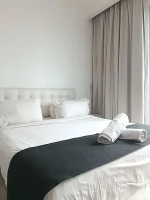 a bedroom with a bed with towels on it at RM238 Bukit Bintang Balcony Studio Infinty Pool in Kuala Lumpur