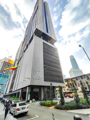 a tall building with cars parked in front of it at The Axon Residence - Bukit Bintang Kuala Lumpur in Kuala Lumpur