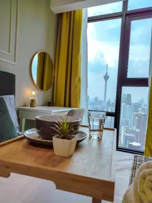 a table with a plate on top of a room with a window at The Axon Residence - Bukit Bintang Kuala Lumpur in Kuala Lumpur