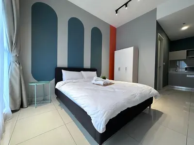 a bedroom with a large bed with blue walls at KL Trion Residence near Velocity - IKEA - Lalaport - Bukit Bintang in Kuala Lumpur