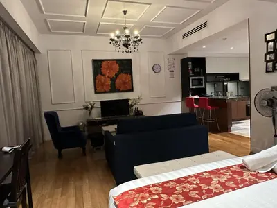 a living room with a couch and a dining room at Klcc studio with a rooftop garden playground in Kuala Lumpur