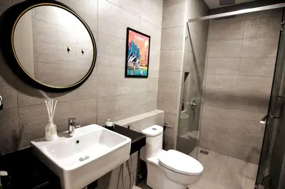 a bathroom with a sink and a toilet and a mirror at The Play Suite@Pano. MRT. Free Parking. Self C/In in Kuala Lumpur