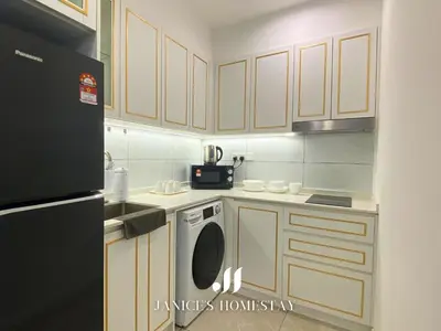 a small kitchen with white cabinets and a dishwasher at Axon Residences Bukit Bintang by Janice's Homestay in Kuala Lumpur