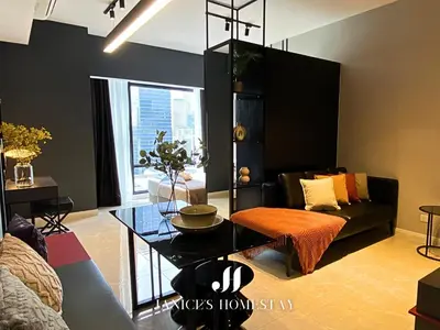 a living room with a black couch and a table at Axon Residences Bukit Bintang by Janice's Homestay in Kuala Lumpur