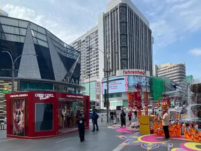 a busy city street with people and buildings at KAĨTE Homestay at Fahrenheit88 Bukit Bintang, Opposite Pavilion KL in Kuala Lumpur
