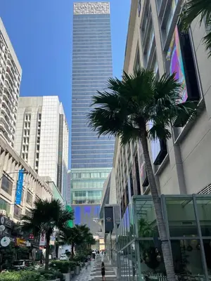 a city street with palm trees and tall buildings at KAĨTE Homestay at Fahrenheit88 Bukit Bintang, Opposite Pavilion KL in Kuala Lumpur