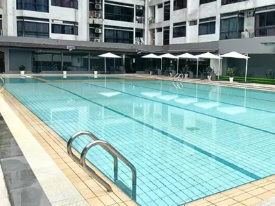 a large swimming pool in a large building at KAĨTE Homestay at Fahrenheit88 Bukit Bintang, Opposite Pavilion KL in Kuala Lumpur