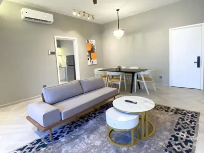 a living room with a couch and a table at KAĨTE Homestay at Fahrenheit88 Bukit Bintang, Opposite Pavilion KL in Kuala Lumpur