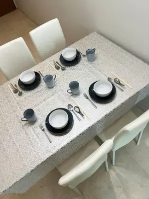 a table with plates and utensils on it at Soho Suites, Centrally Located at KL City Centre in Kuala Lumpur
